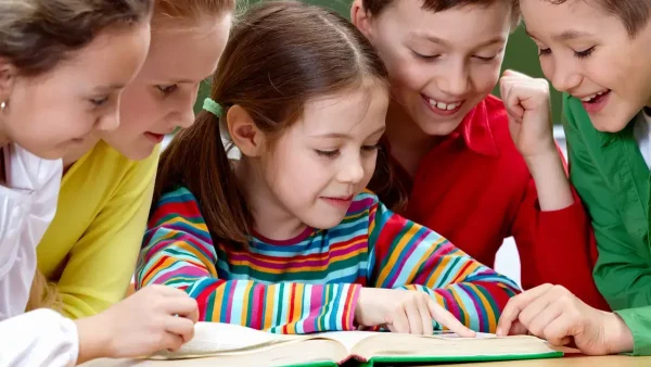 Estudiantes primarios leyendo un libro